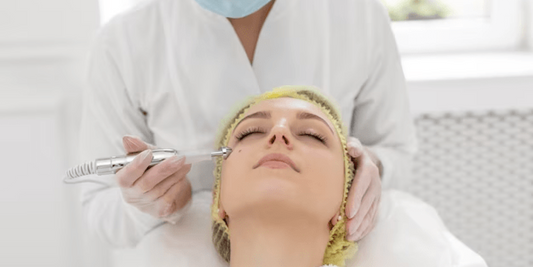 A licensed aesthetician carefully performs a dermaplaning procedure on a client's cheek using a sterile, surgical-grade scalpel to remove vellus hair and dead skin cells.