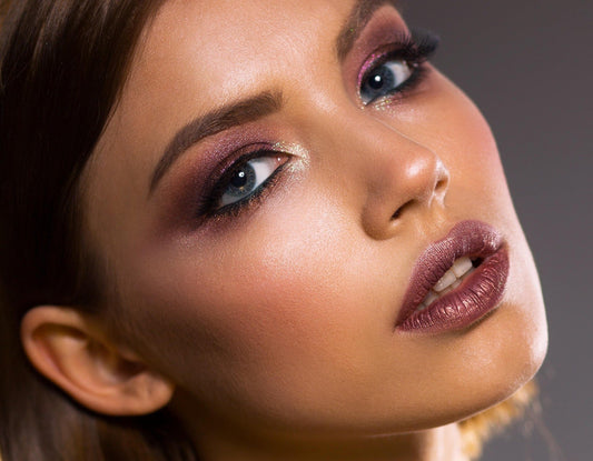Woman with smooth, glowing skin after dermaplaning — benefits of dermaplaning guide